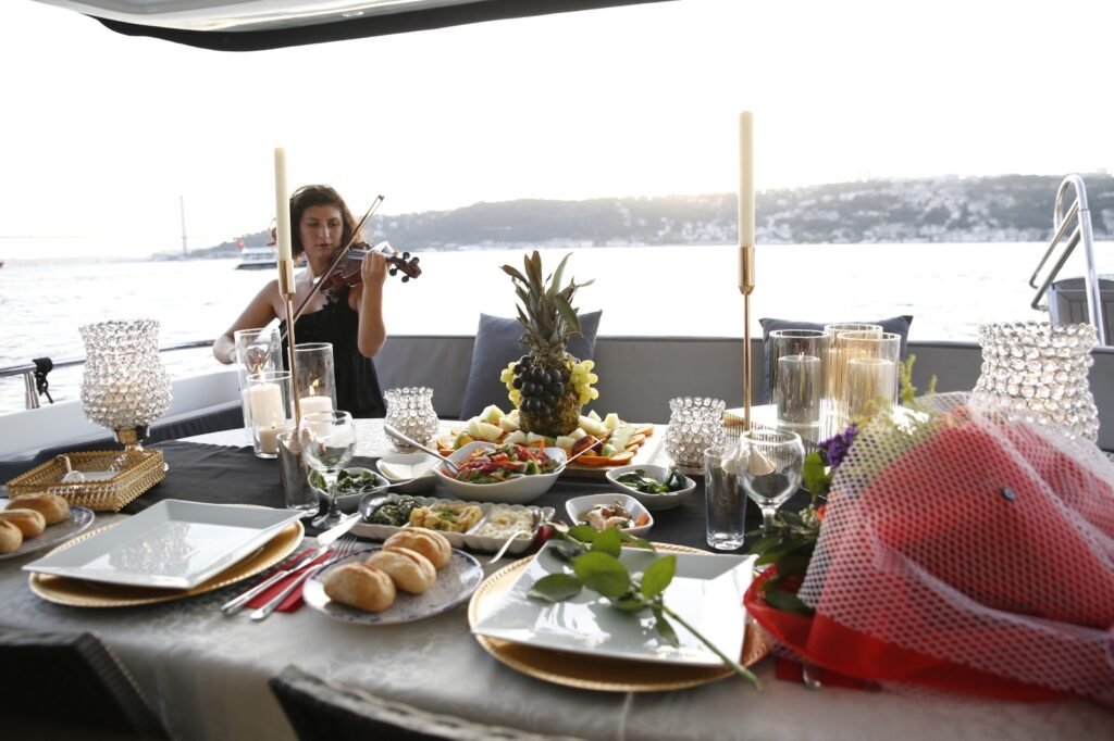 Romantic dinner setup on a private yacht with live violin music on the Bosphorus in Istanbul.